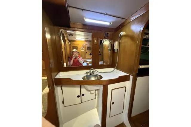 Slide: The Image of 1980 Mao Ta Skye 51 yacht bathroom with wooden cabinetry and mirror. - 27