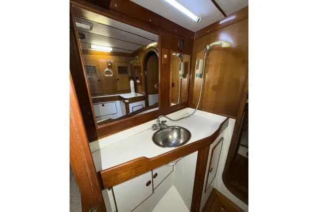 Slide: The Image of 1980 Mao Ta Skye 51 yacht bathroom with wooden cabinetry and stainless steel sink. - 28