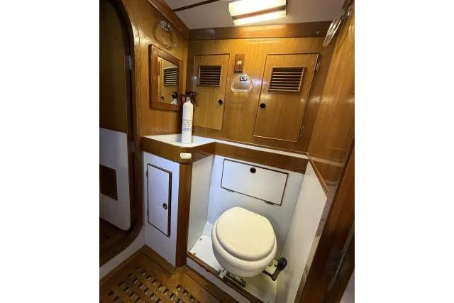 Slide: The Image of 1980 Mao Ta Skye 51 yacht bathroom with wooden cabinetry and compact toilet. - 30