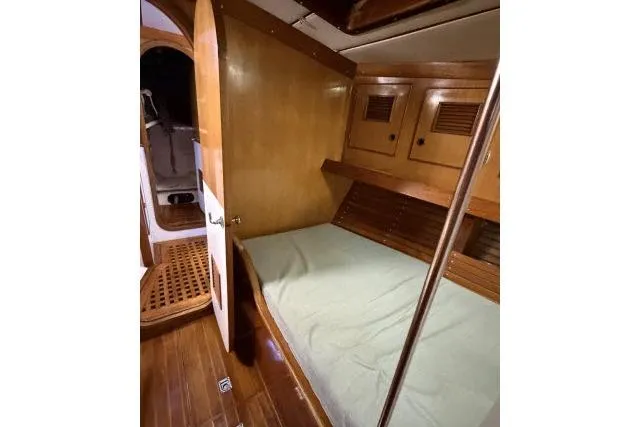 Slide: The Image of 1980 Mao Ta Skye 51 yacht cabin with wooden interior and cozy bed. - 31