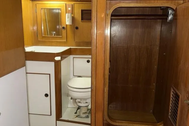 Slide: The Image of 1980 Mao Ta Skye 51 yacht bathroom with wooden cabinetry and compact toilet. - 39