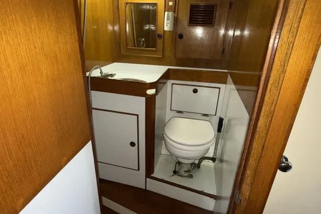 Slide: The Image of 1980 Mao Ta Skye 51 yacht bathroom with wooden cabinetry and compact design. - 40