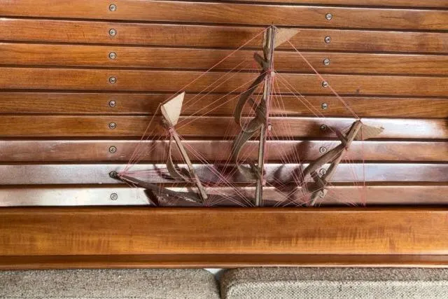 Slide: The Image of Wooden interior of 1980 Mao Ta Skye 51 yacht with decorative ship model. - 5