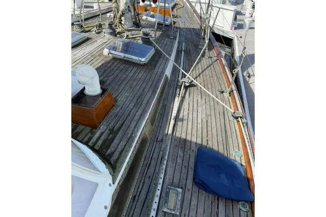 Slide: The Image of 1980 Mao Ta Skye 51 sailboat deck with wooden finish and nautical equipment. - 53