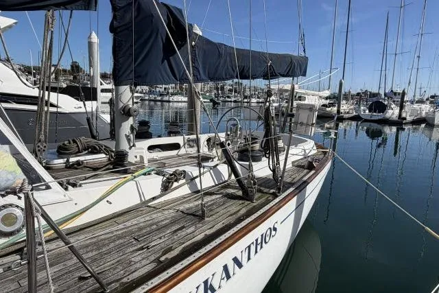Slide: The Image of Sailboat "Mao Ta Skye 51" from 1980 docked in a marina, surrounded by other boats. - 70