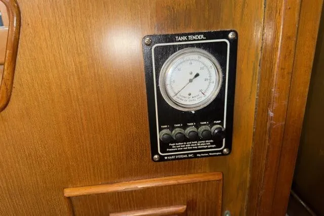 Slide: The Image of Tank tender gauge on 1980 Mao Ta Skye 51 yacht, wooden panel background. - 74