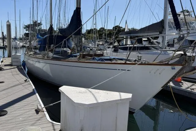 Slide: The Image of 1980 Mao Ta Skye 51 sailboat docked at a marina, surrounded by other boats. - 78