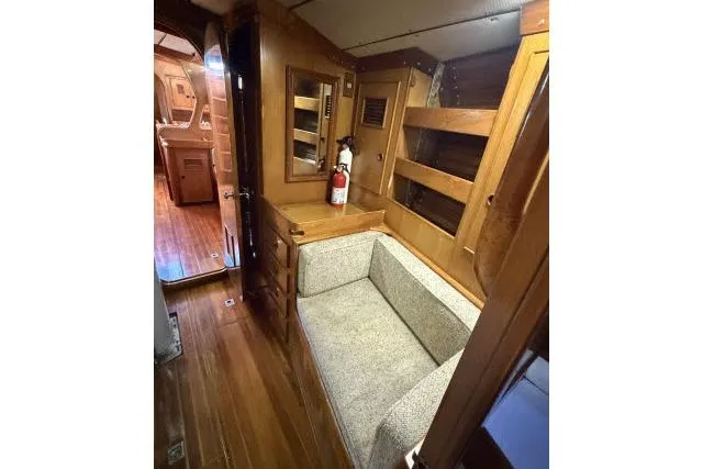 Slide: The Image of Interior of 1980 Mao Ta Skye 51 yacht with wooden furnishings and seating area. - 8