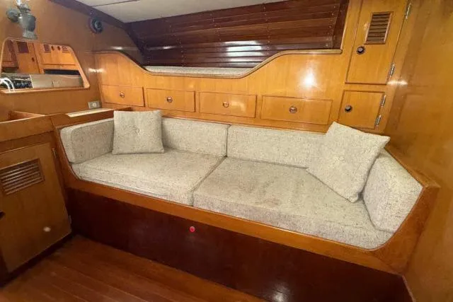 Slide: The Image of Interior of 1980 Mao Ta Skye 51 yacht with wooden cabinetry and cushioned seating. - 9