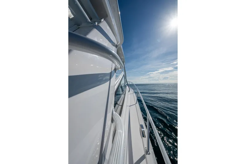 Slide: The Image of Side view of 2023 Intrepid 477 Evolution yacht cruising on open sea. - 11