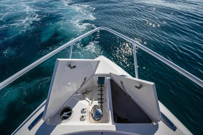 Slide: The Image of Bow view of 2023 Intrepid 477 Evolution yacht on sparkling blue water. - 13