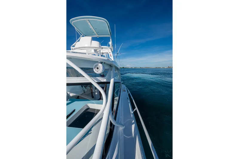 Slide: The Image of 2023 Intrepid 477 Evolution yacht cruising on clear blue waters under a sunny sky. - 17