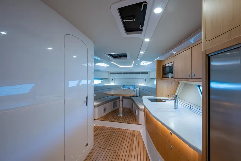 Slide: The Image of Luxurious interior of 2023 Intrepid 477 Evolution yacht with modern kitchen and seating area. - 19