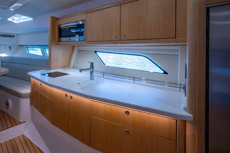 Slide: The Image of Luxurious 2023 Intrepid 477 Evolution yacht interior with modern kitchen and sleek design. - 20