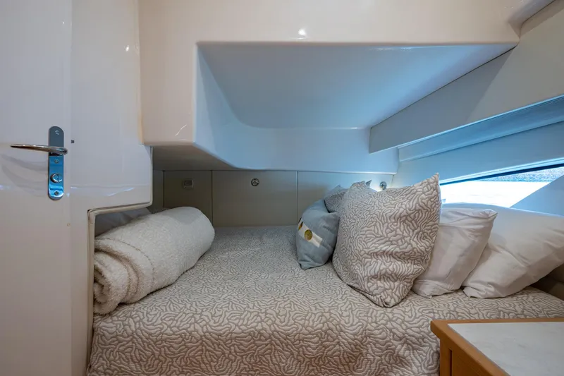 Slide: The Image of Cozy cabin interior of 2023 Intrepid 477 Evolution yacht with plush bedding and modern design. - 32