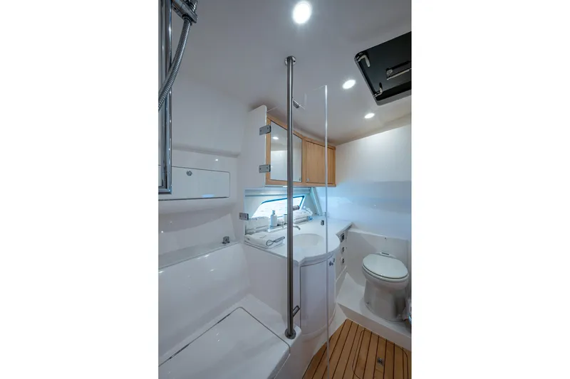 Slide: The Image of Luxurious bathroom interior of 2023 Intrepid 477 Evolution yacht, featuring modern fixtures and wooden accents. - 34