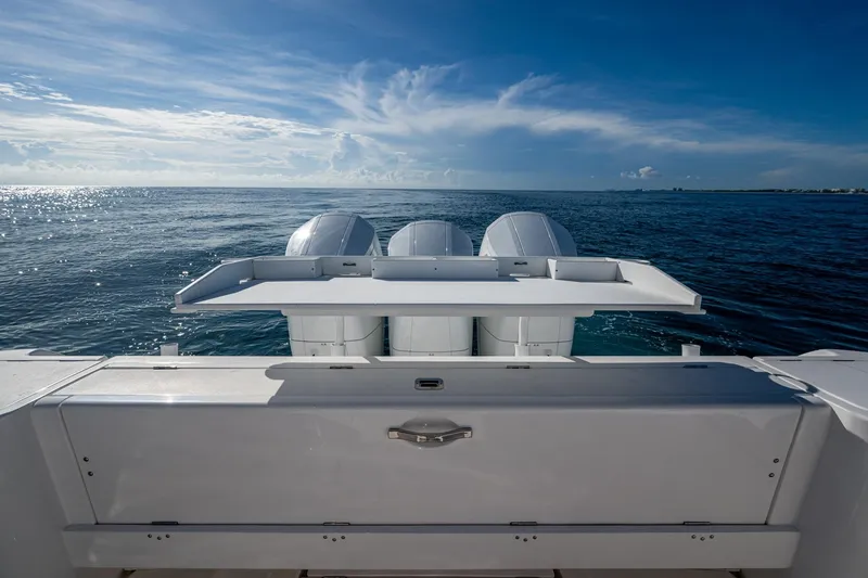 Slide: The Image of 2023 Intrepid 477 Evolution boat with triple outboard engines on open sea. - 40