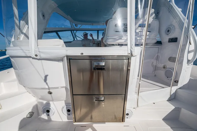 Slide: The Image of 2023 Intrepid 477 Evolution yacht interior with stainless steel storage and seating area. - 45