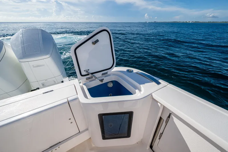 Slide: The Image of 2023 Intrepid 477 Evolution boat with open storage compartment, ocean view. - 47