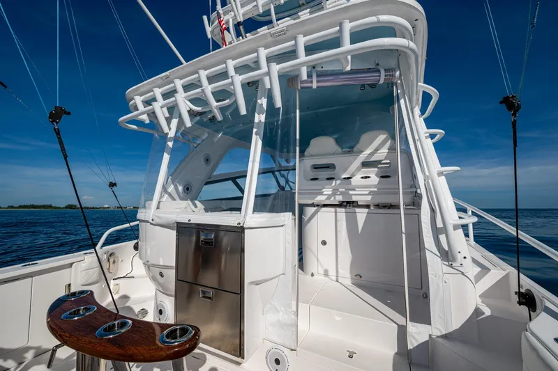 Slide: The Image of 2023 Intrepid 477 Evolution boat cockpit with fishing rods and ocean view. - 54