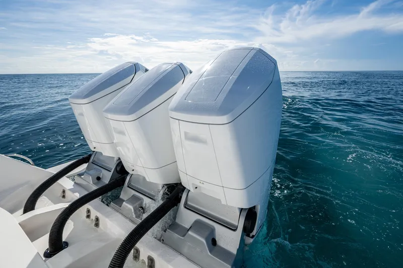Slide: The Image of 2023 Intrepid 477 Evolution boat engines on open sea, showcasing sleek design and power. - 56