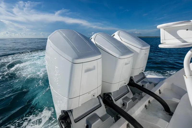 Slide: The Image of 2023 Intrepid 477 Evolution boat engines on open water, showcasing power and performance. - 57