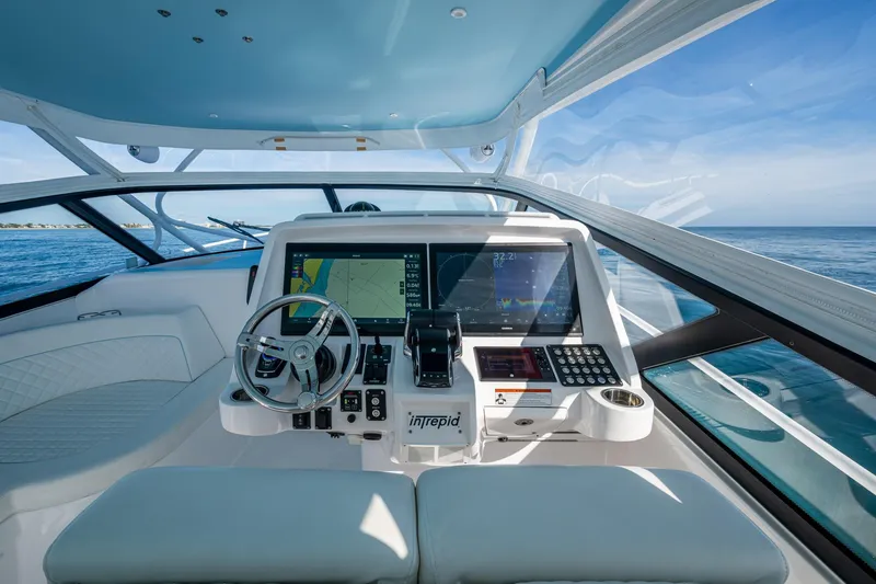 Slide: The Image of Cockpit of 2023 Intrepid 477 Evolution yacht with advanced navigation system. - 60