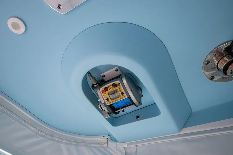 Slide: The Image of 2023 Intrepid 477 Evolution boat interior with mounted electronic fishing reel. - 67