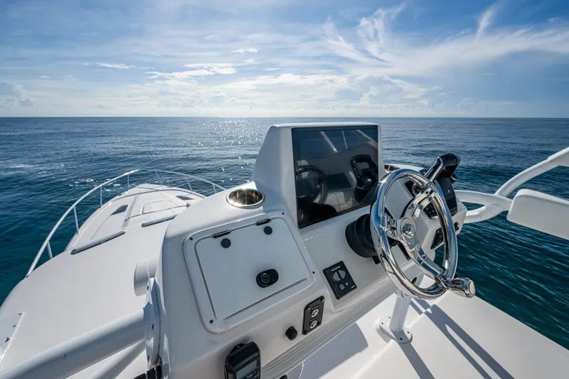 Slide: The Image of 2023 Intrepid 477 Evolution boat helm with ocean view and clear blue sky. - 88