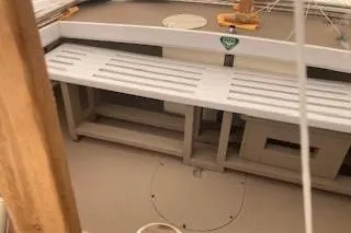 Slide: The Image of 1984 BHM CC Flye Point Launch interior with wooden bench and storage compartments. - 11