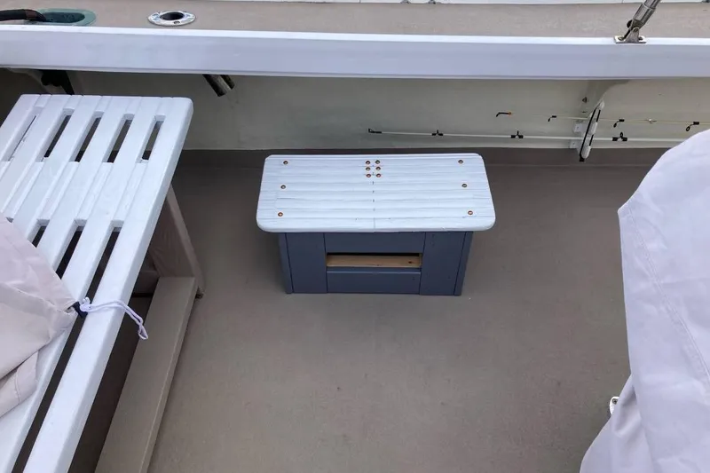 Slide: The Image of 1984 BHM CC Flye Point Launch boat interior with white bench and step stool. - 12