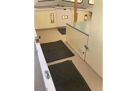 Slide: The Image of 1984 BHM CC Flye Point Launch interior with mats and storage cabinets. - 13