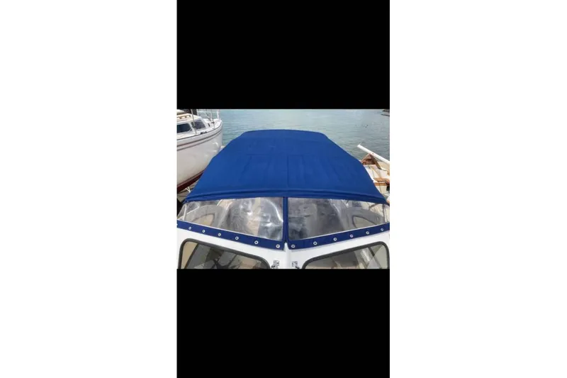 Slide: The Image of 1984 BHM CC Flye Point Launch with blue canopy on calm water. - 14