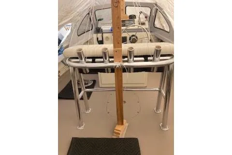 Slide: The Image of 1984 BHM CC Flye Point Launch interior with steering console and rod holders. - 7