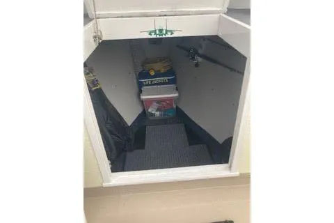 Slide: The Image of Interior cabin of 1984 BHM CC Flye Point Launch with life jackets and storage. - 9