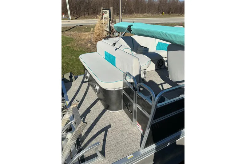 Slide: The Image of 2021 Qwest LS 824 Lanai DS Bar pontoon boat with teal and white seating. - 12