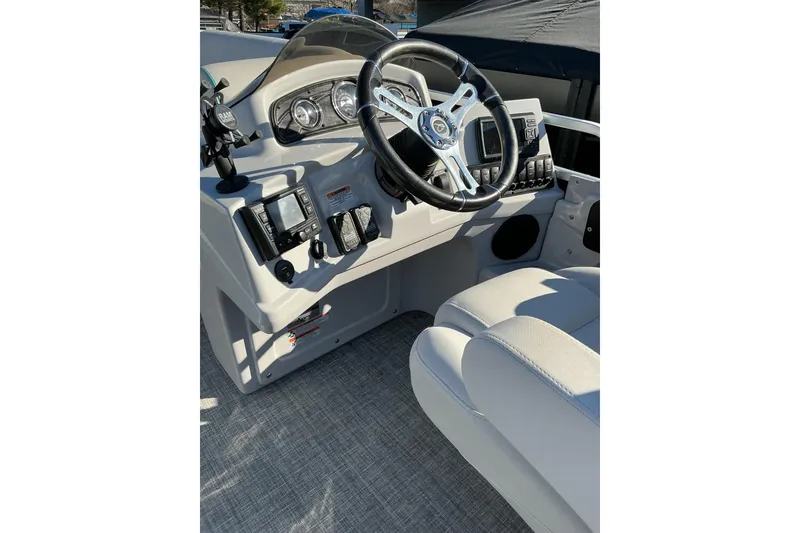 Slide: The Image of Cockpit of 2021 Qwest LS 824 Lanai DS Bar boat with steering wheel and controls. - 14