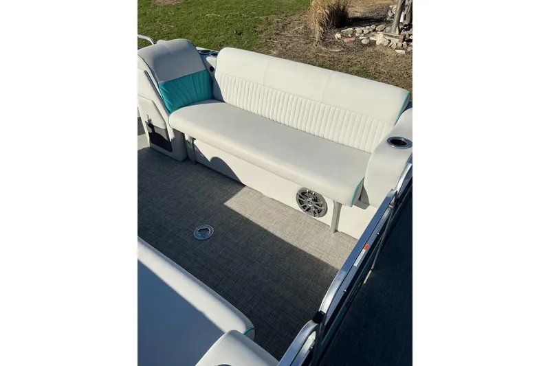 Slide: The Image of 2021 Qwest LS 824 Lanai DS Bar boat interior with white seating and speaker. - 16