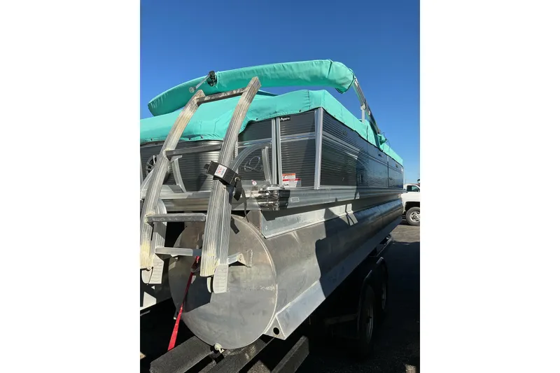 Slide: The Image of 2021 Qwest LS 824 Lanai DS Bar pontoon boat with teal canopy, rear view. - 5