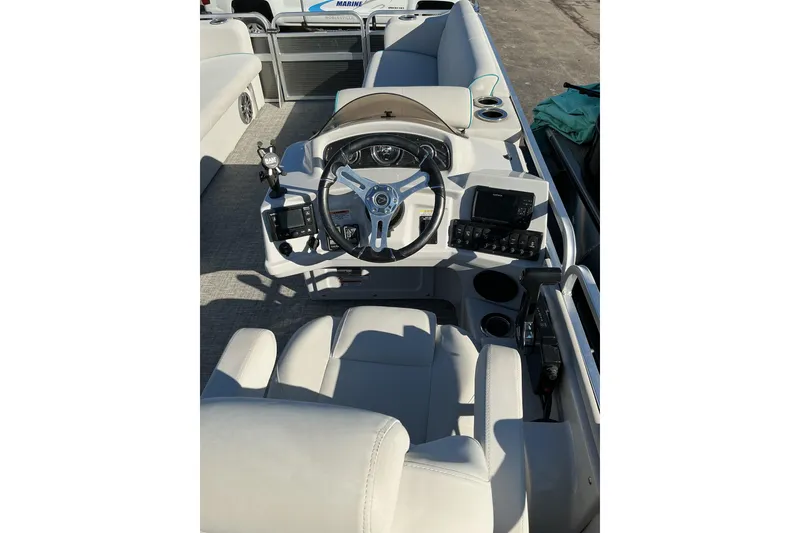 Slide: The Image of 2021 Qwest LS 824 Lanai DS Bar boat interior with steering wheel and control panel. - 9