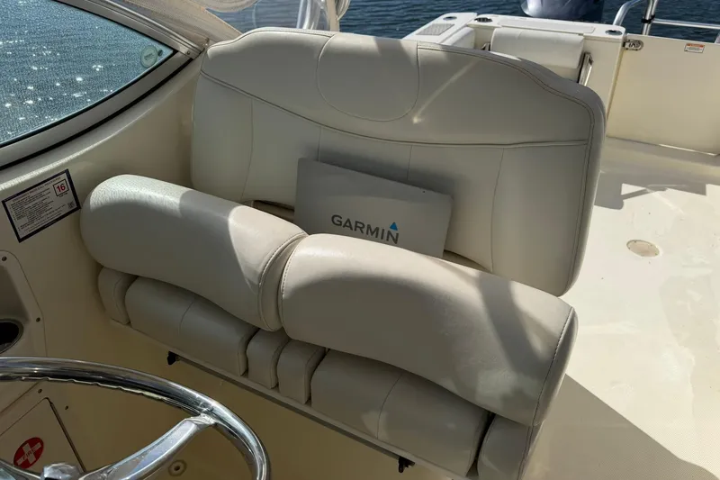 Slide: The Image of 2013 World Cat 290 DC boat interior with Garmin equipment and cushioned seating. - 16