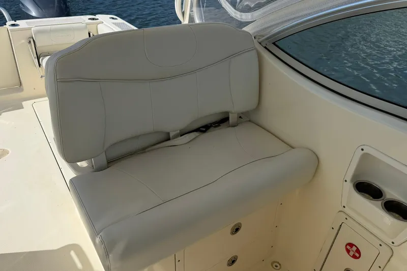 Slide: The Image of 2013 World Cat 290 DC boat interior with cushioned seating and cup holders. - 17