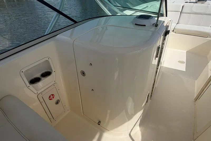 Slide: The Image of 2013 World Cat 290 DC boat interior with seating and storage compartments. - 18