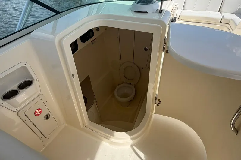 Slide: The Image of Interior view of 2013 World Cat 290 DC boat's compact bathroom area. - 19