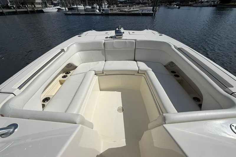 Slide: The Image of 2013 World Cat 290 DC boat with spacious seating area on calm water. - 24