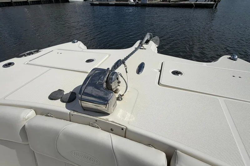 Slide: The Image of 2013 World Cat 290 DC boat deck with anchor chain and winch by the water. - 25
