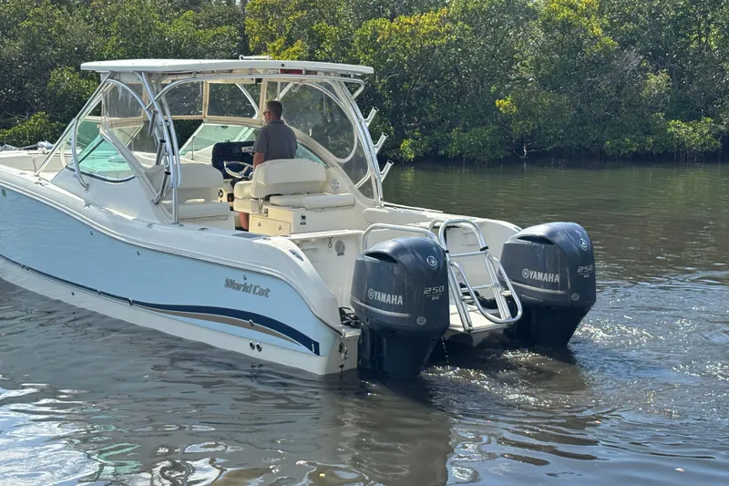 Slide: The Image of 2013 World Cat 290 DC boat with dual Yamaha engines on calm water. - 6