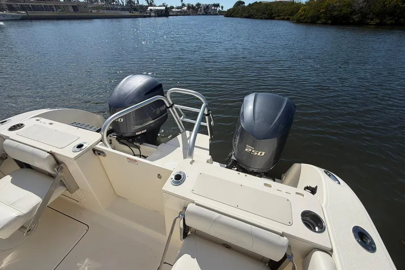 Slide: The Image of 2013 World Cat 290 DC boat with twin Yamaha 250 engines on calm water. - 9