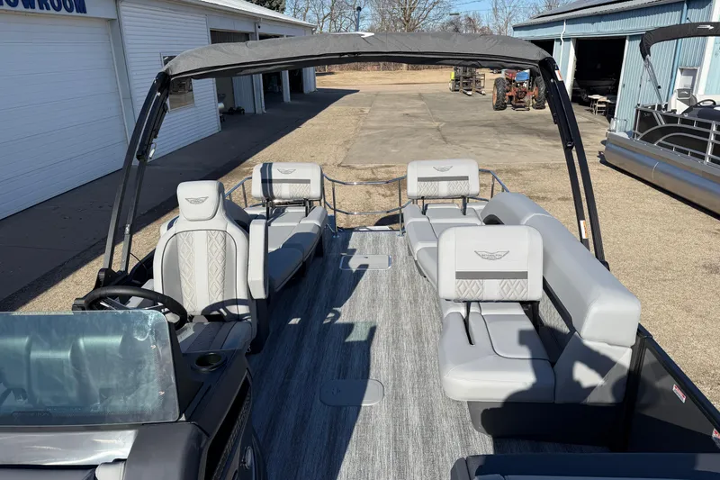 Slide: The Image of 2026 Bennington 24 M Sport Lounge Quad Bench pontoon boat with elegant seating and canopy. - 13
