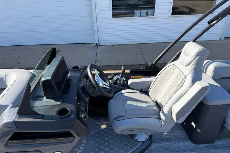 Slide: The Image of 2026 Bennington 24 M Sport Lounge Quad Bench, luxurious helm and seating area. - 16